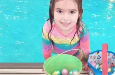 child at pool egg hunt