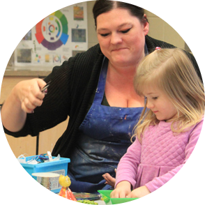 Art instructor with little girl