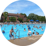 Many people in the outdoor pool