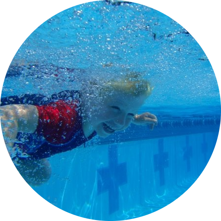Little girl smiling and swimming underwater