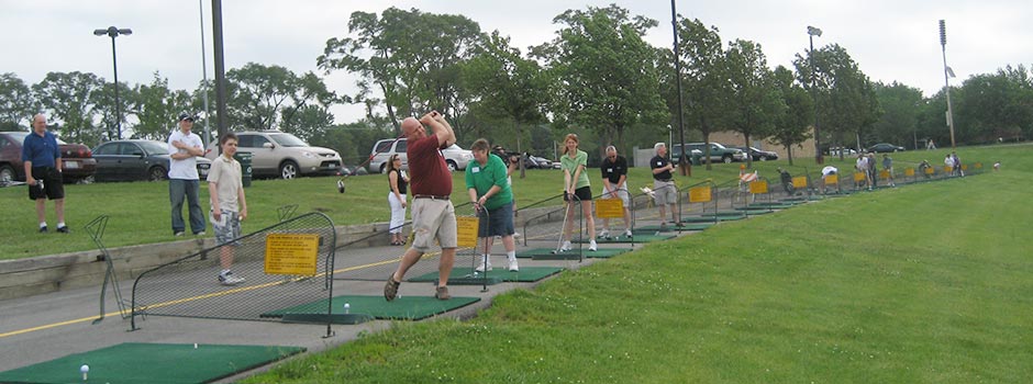 People hitting golf balls at Sunset Meadow Driving Range